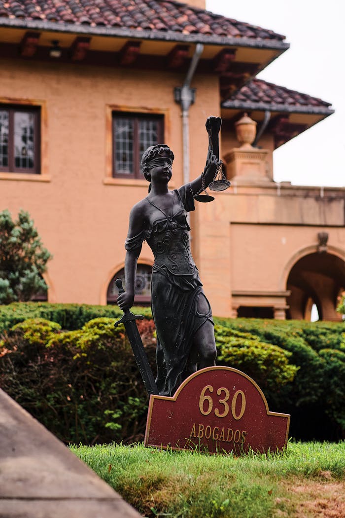 Bronze Lady Justice statue at Arizona law firms entrance, symbolizing fairness.